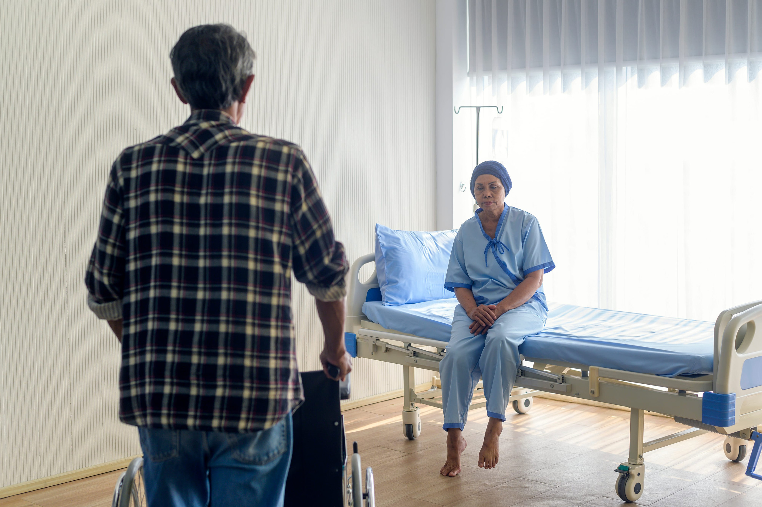 Caregiver attending to a patient during hospital recovery