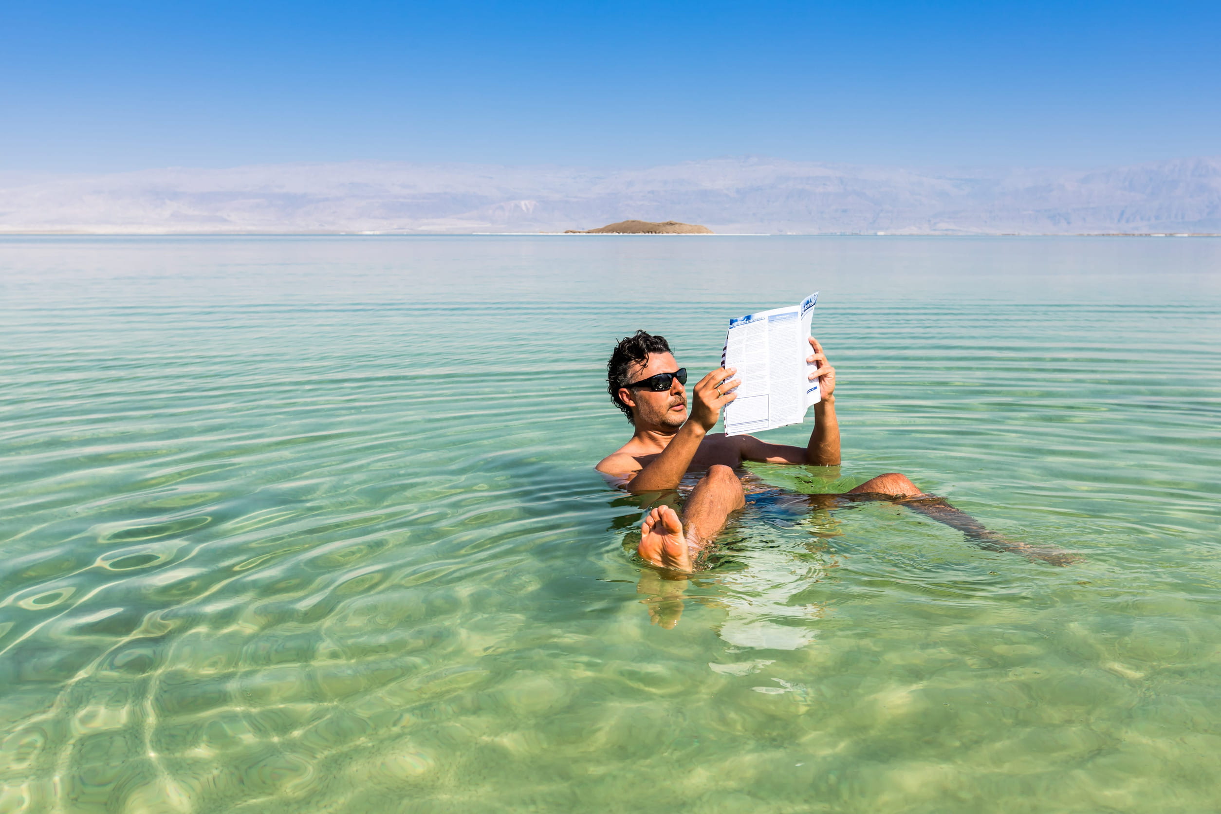 Man floating on the waters of the Dead Sea