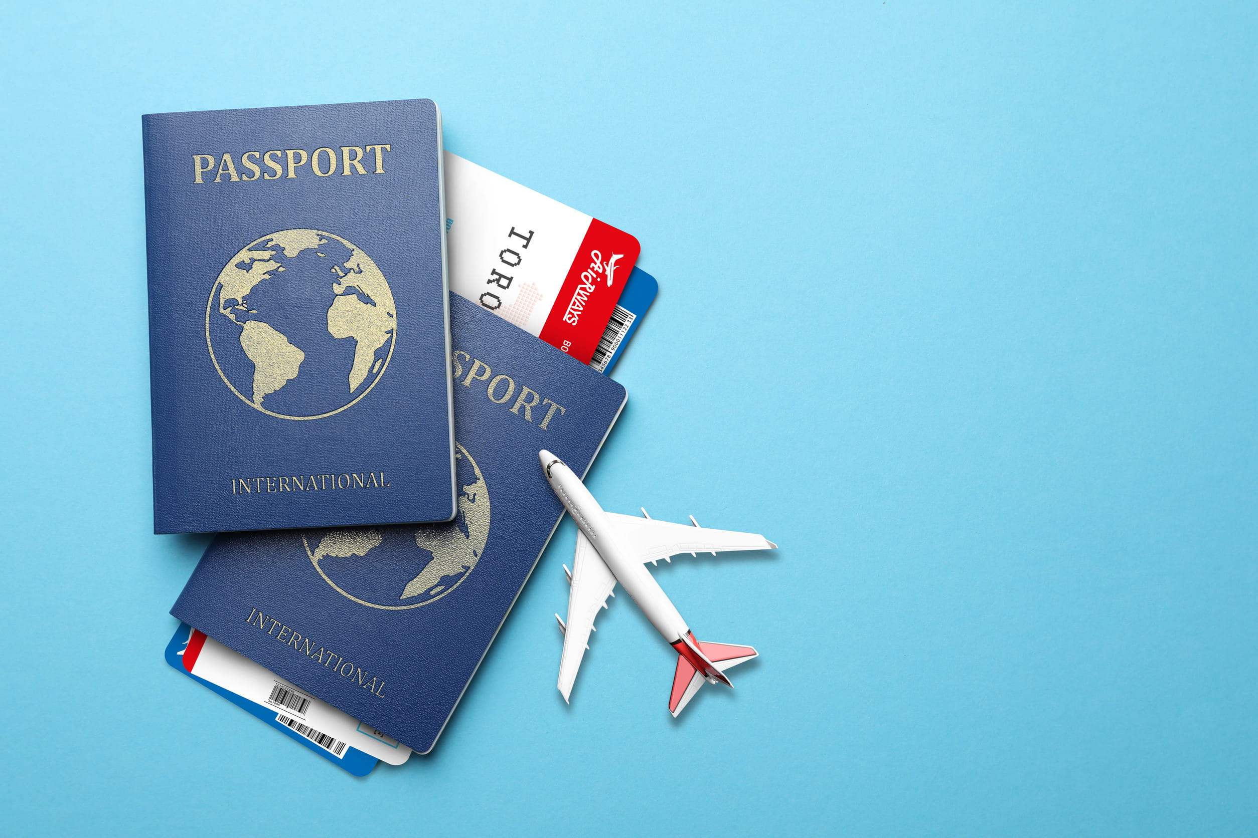 Two Passports With A Miniature Airplane